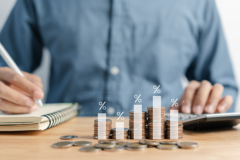 Businessman stacking money coins accounting